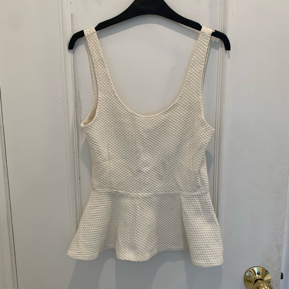 Ganni sleeveless peplum top in off-white. Size XS